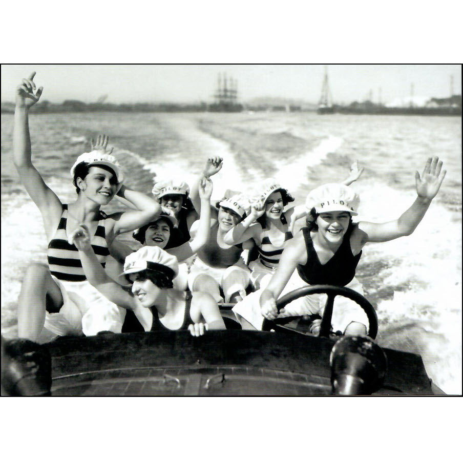 A bevy of smiling women sporting sailor stripes and pilot caps are having fun in California as they take a spin in a fast wooden power boat. The image was taken in Long Beach California in 1928.