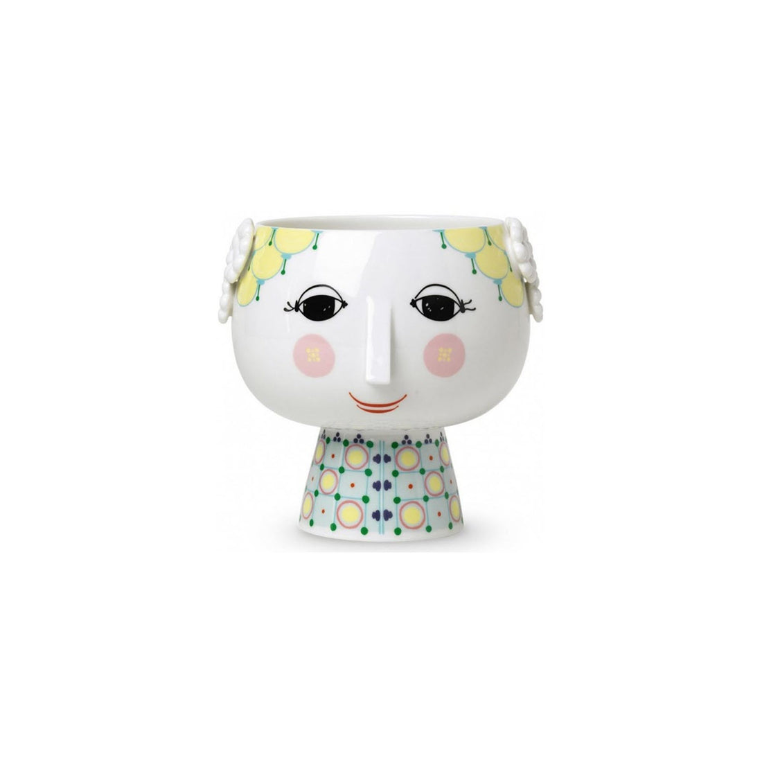  A whimsical flowerpot designed to look like a stylized face, featuring yellow lemon motifs on the rim, prominently displayed eyes and a smiling mouth on a white backdrop with delicate line patterns. The pot's base resembles a shirt with a colorful geometric pattern.