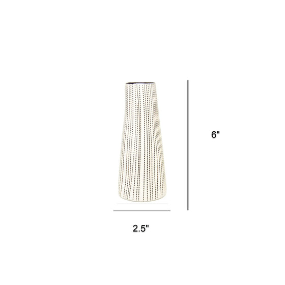 A tall cylindrical vase with a white and black dotted stripe pattern. The vase has a slight taper towards the top and a black rimmed opening. Also noted are the dimensions of 2.5” wide at the bottom by 6” tall.